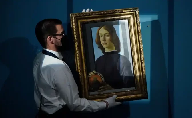 Sandro Botticelli’s Young Man Holding a Roundel sold at Sotheby’s in New York for $92.2m, an auction record for the Renaissance artist. Photograph: Carlo Allegri/Reuters